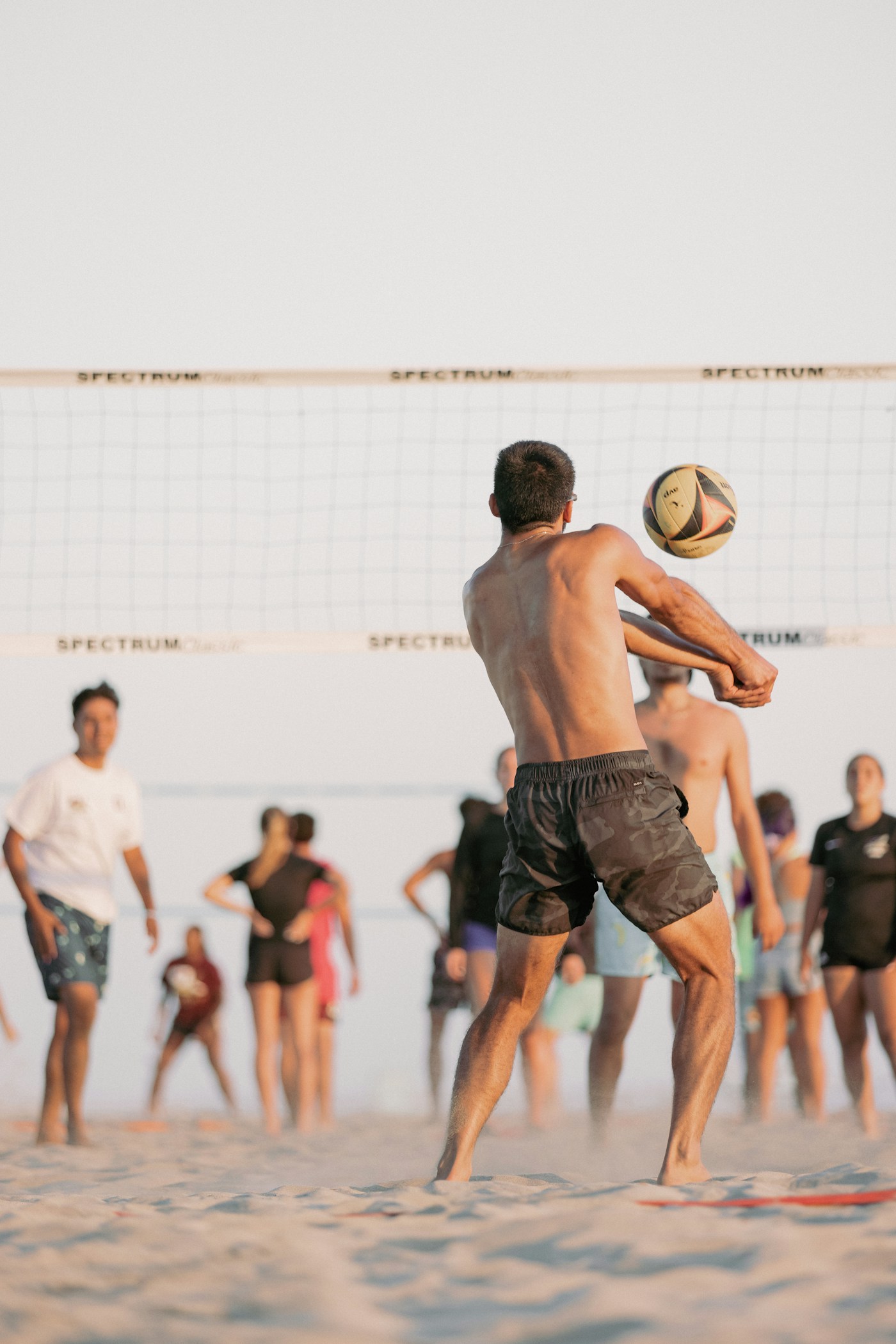 Friends playing beach volleyball on the sand